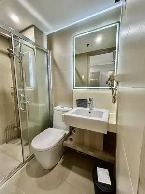 a bathroom with a toilet and a sink and a shower at Prime Makati Condo Near Poblacion & Malls in Manila