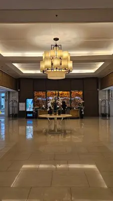 a large lobby with a table and a chandelier at Shell MOA Facing View 1BR near Ikea, NAIA, PICC Shell003 in Manila