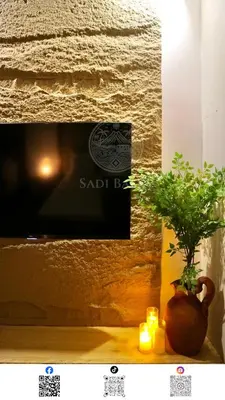 a plant in a vase sitting on a table with candles at 3 min to Rockwell City View Pool Parking in Manila
