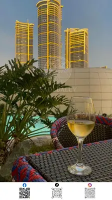 a glass of wine sitting on top of a table at 3 min to Rockwell City View Pool Parking in Manila