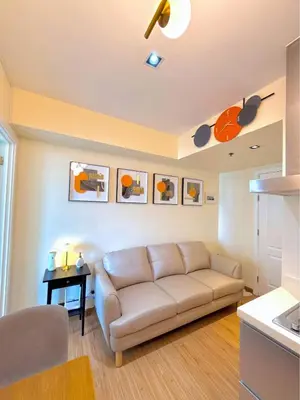 a living room with a couch and a table at Azure Urban Resort 1BR-2BR St Tropez in Manila