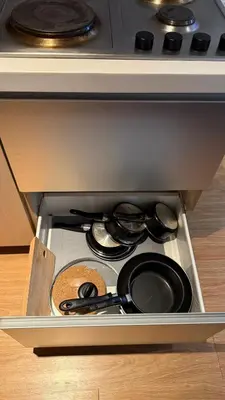 a drawer in a stove with pots and pans at Azure Urban Resort 1BR-2BR Boracay in Manila