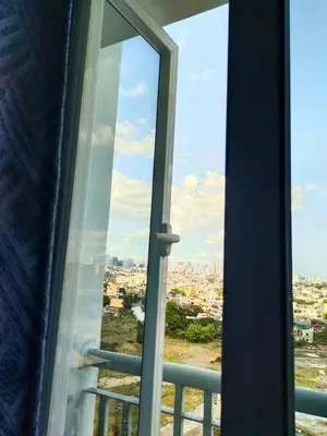 a view of a city from a window at Aureascondo in Manila