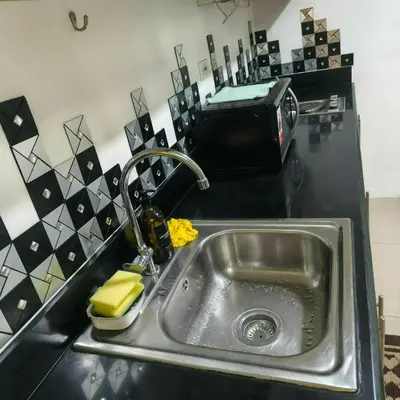 a kitchen counter with a sink and a toaster at Shore Recidences Mall Of Asia Cullen in Manila