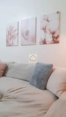 a bedroom with a bed with four pictures on the wall at Aludia's Dreamplace in Manila