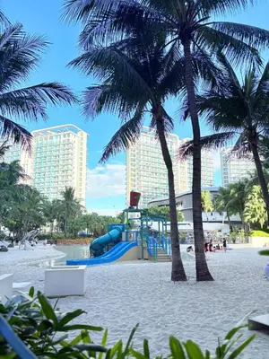 a playground on the beach with palm trees at Ohana JPL Azure Staycation in Manila