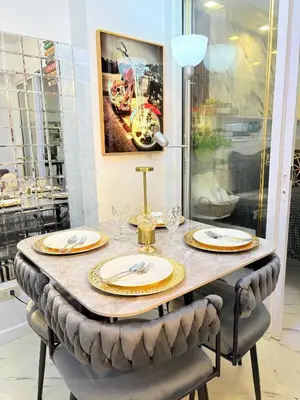 a table with chairs and plates on top of it at Ohana JPL Azure Staycation in Manila
