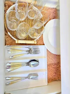 a drawer with silver utensils on a table at Ohana JPL Azure Staycation in Manila