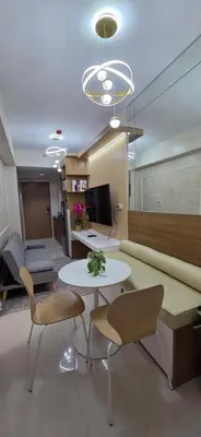 a living room with a couch and a table and chairs at The Shore 3 Chic Suite in Manila