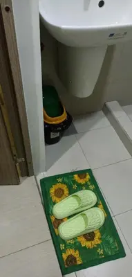 a bathroom with a green rug on the floor next to a toilet at SM Mall of Asia Shore2 Tower2 Nano Nap&Go in Manila