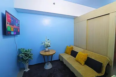 a living room with a couch and a table at Comfy 1BR Self Check-In at Light Residences in Manila