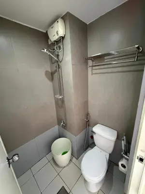 a small bathroom with a toilet and a shower at PaulBert's Cabins III in Manila