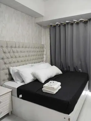 a small bedroom with a bed with a black and white mattress at Spacious 2BR in Shore3 in Manila