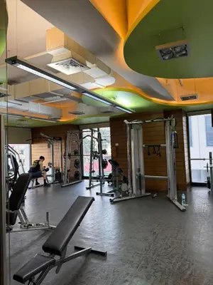 a gym with several tread machines in a room at Deluxe Room with Pool View Unit in Poblacion in Manila