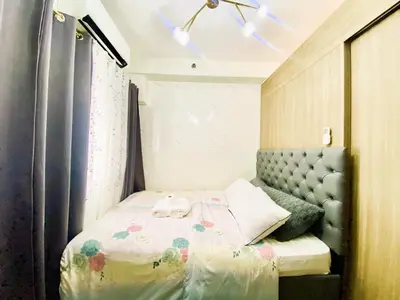 a small bedroom with a bed and a window at Ameera Condo Stay in Manila