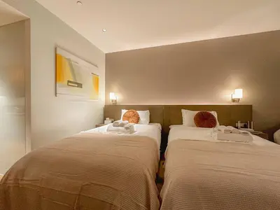 two beds sitting next to each other in a room at Premium Twin Suite at Novotel Acqua - City View in Manila