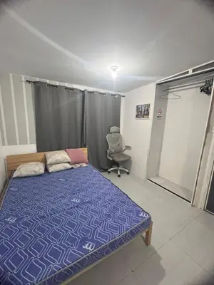 a bedroom with a bed and a chair in it at Alilonch Transient