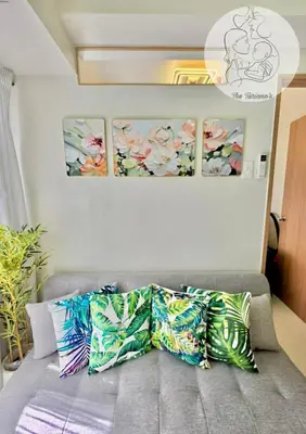 a couch with pillows on it in a room at The Turianos in Manila