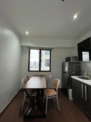 a kitchen with a table and chairs in a room at STAYLUXIA BOUTIQUE HOTEL KNIGHTSBRIDGE Pool Netflix Free Amenities in Manila