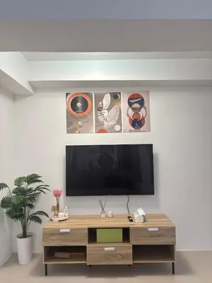 a living room with a flat screen tv on a wall at Condo Unit in Parañaque by Casa Esplanade in Manila