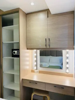 a bedroom with a desk with a bed in it at Sea Residences in Manila