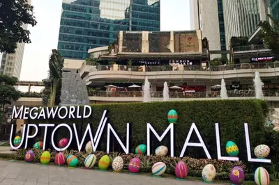 a sign in front of a park with easter eggs at Uptown Parksuites - Elegant 2 Bedroom Unit with Balcony in BGC in Manila