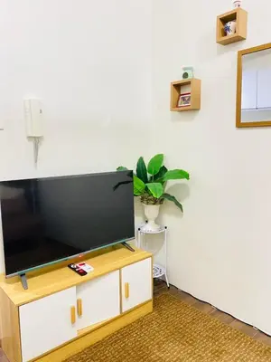 a flat screen tv sitting on top of a cabinet at Air Residences in Manila