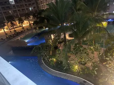 an overhead view of a swimming pool at night at Shore residence A42 shortwalk mall of asia in Manila
