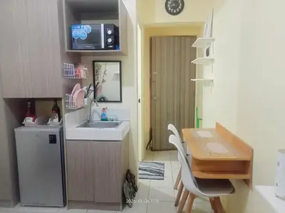 a small kitchen with a table and a sink at Urban Deca Tower at Mandaluyong in Manila