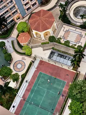 an overhead view of a tennis court in a city at Luxe Spacious Cozy Venice BGC 65inTV Surround Sound in Manila