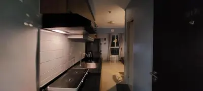 a small kitchen with a sink and a stove at Avida Sucat Paranaque City in Manila