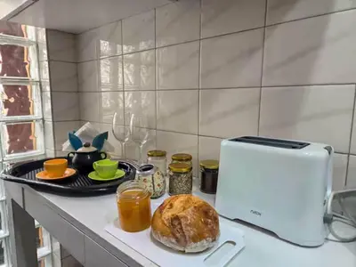 a kitchen counter with a loaf of bread and a toaster at Pure Stay Apartments in Manila