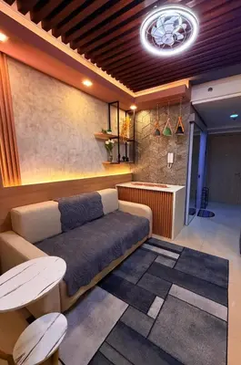 a living room with a couch and a bar at Bayshore Getaway Condotel ByClowie in Manila