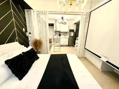 a bedroom with a large bed with a black and white at Dream Catchers Azure Staycation in Manila