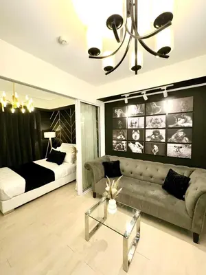 a living room with a couch and a bed at Dream Catchers Azure Staycation in Manila