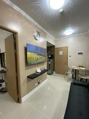 a living room with a table and a dining room at 2 BR Fully Furnished Condo in Parañaque with Pool and Parking - Bloom Unit 1134 in Manila