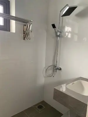 a white bathroom with a sink and a shower at Magallanes Escape in Manila