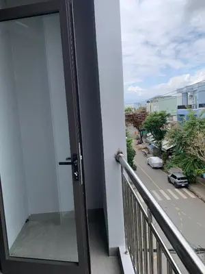 a balcony with a glass door with a view of a street at Magallanes Escape in Manila
