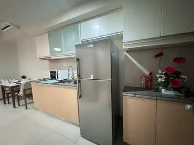 a kitchen with a stainless steel refrigerator in a room at BGC Luxe Condo I Facing Grand Hyatt & Uptown Mall in Manila