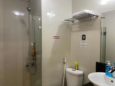 a bathroom with a shower and a toilet and a sink at Theresa Place Like Home in Manila