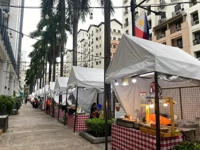 a row of white tents on a city street at Theresa Place Like Home in Manila