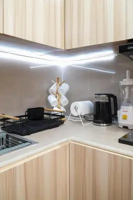 a kitchen with a counter with a stove top oven at Cozy Staycation in The Radiance Manila Bay in Manila