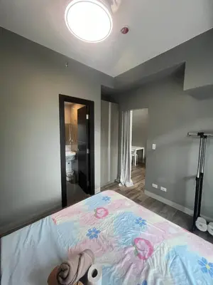 a bedroom with a large bed with a large at Cozy Gentry Manor TV Netflix Seaview near Okada MOA17V in Manila