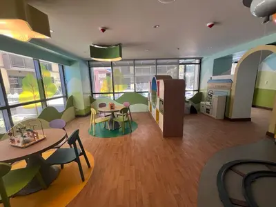 a living room with a table and chairs and a dining room at Gentry Manor WiFi Netflix&Balcony Near Okada NAIA in Manila