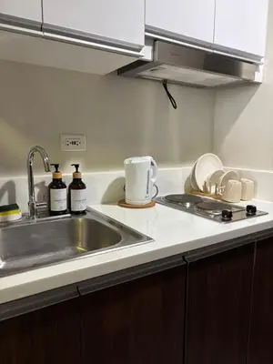 a kitchen with a sink and a counter top at Air Residences Makati CBD 1BR w Balcony in Manila