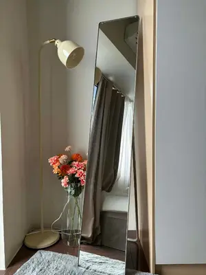 a mirror with a vase of flowers in a room at Air Residences Makati CBD 1BR w Balcony in Manila