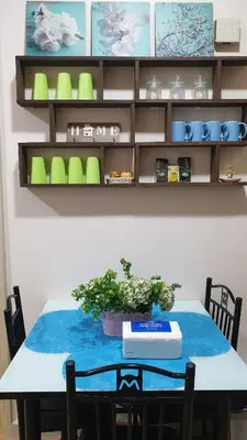 a table with a potted plant on top of it at AC's Suite in Manila
