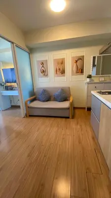 a living room with a couch in a kitchen at Azure Urban Resort Residences in Manila
