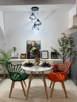a dining room with a table and two chairs at One uptown Residence,BGC, Manila 1bedroom in Manila