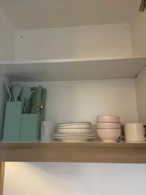a shelf with bowls and other dishes on it at City Point at Shore Residences in Manila